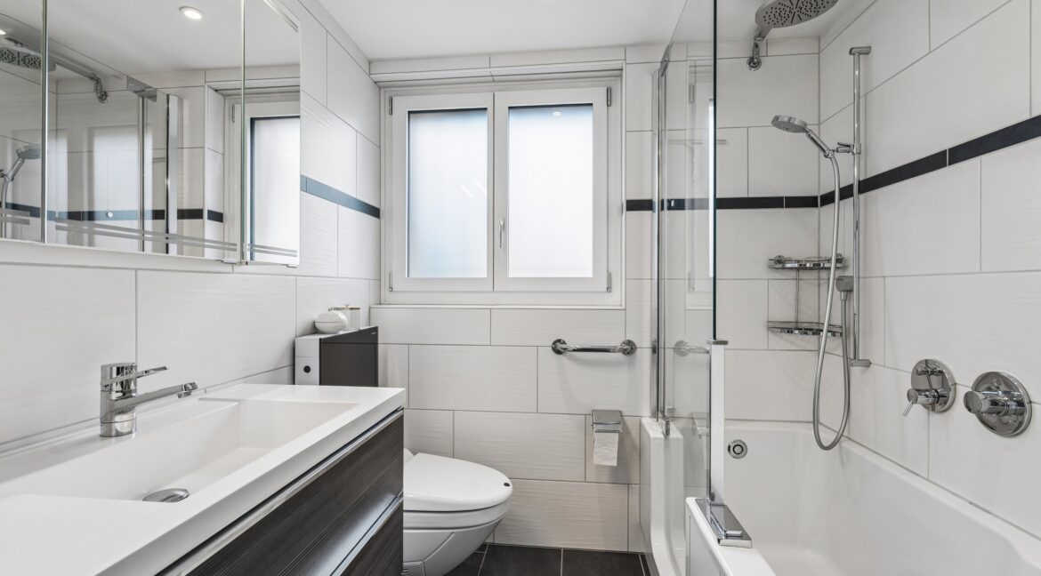 Erdgeschosswohnung: Komfortables Badezimmer mit Badewanne, Dusche, Schränken und Tageslicht